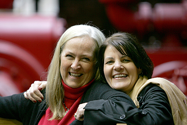 two women, side by side, leaning close to each other